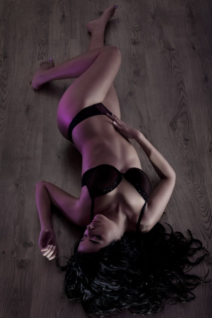 menu-02 Elegant model posing in lingerie on wood floor. Artistic lighting enhances the composition.